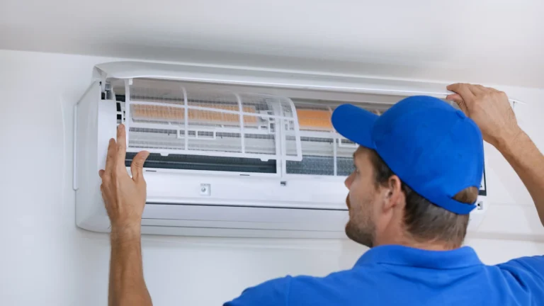 hvac worker with blue outfit installing ac unit